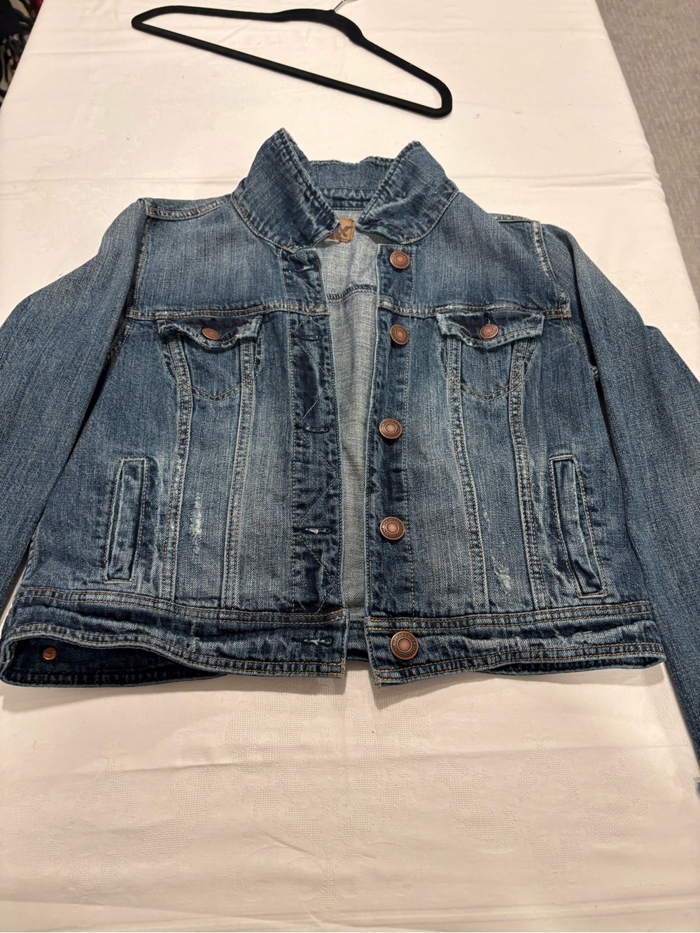 American Eagle Outfitters light blue denim jacket with brown leather patch